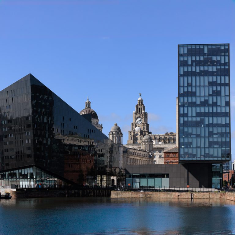 View of the Royal Liver Building reflected in the black glass of Mann Island, Liverpool waterfront