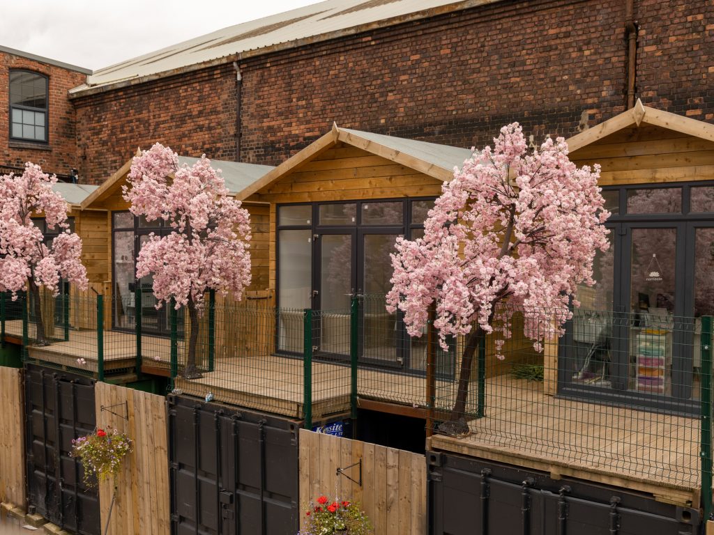 The Secret Warehouse Kirkdale exterior with cherry blossom trees
