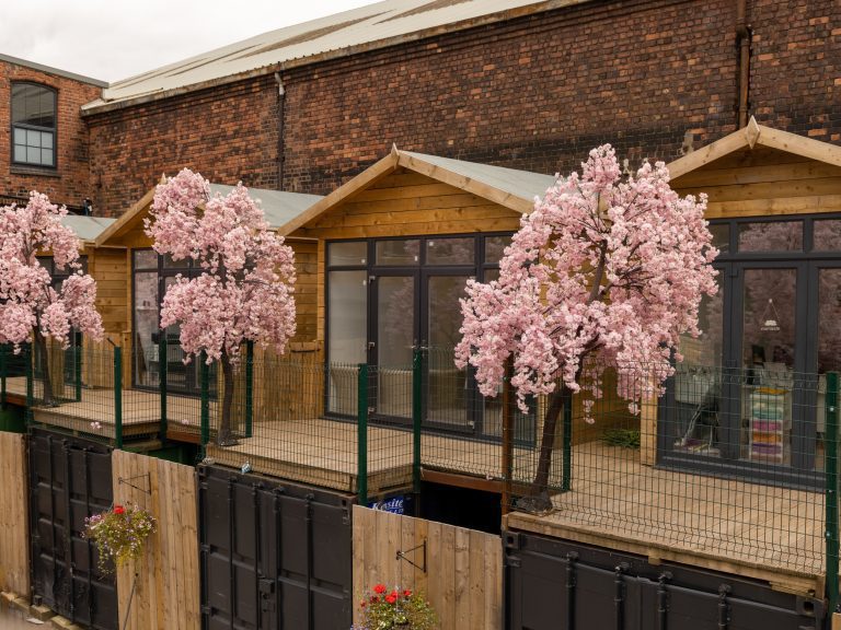 The Secret Warehouse Kirkdale exterior with cherry blossom trees
