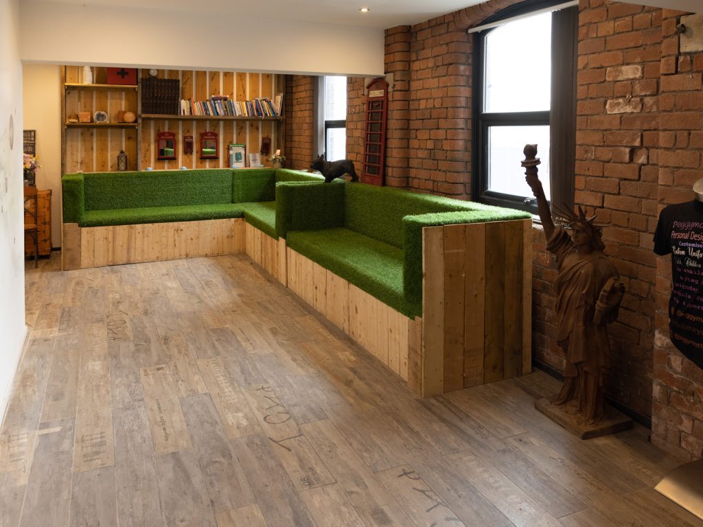 Secret Warehouse Kirkdale reception area with astroturf sofa and London phone boxes