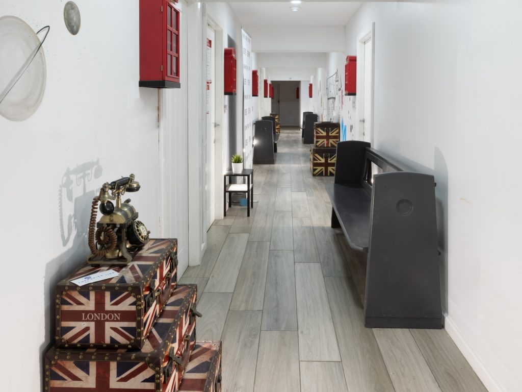 Secret Warehouse Kirkdale corridor with vintage Union Jack suitcases and antique telephone