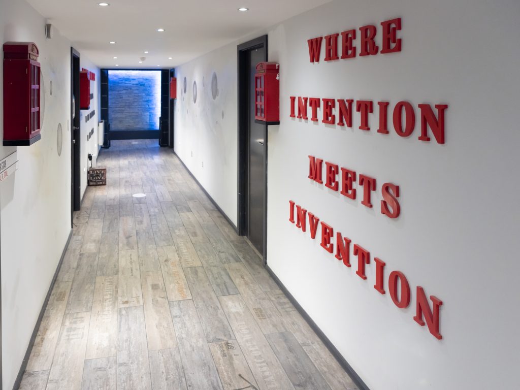 Secret Warehouse Kirkdale corridor wall reading Where Intention Meets Invention