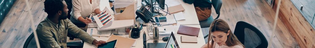 Team working together in a bright open-plan office - workplace headshots
